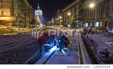Tram rails at the stage of their installation and integration into concrete plates on the road night timelapse Tram rails at the stage of their installation and integration into concrete plates on the road night timelapse 116433324