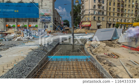 Concrete works for road construction with many workers and concrete pump timelapse 116433339