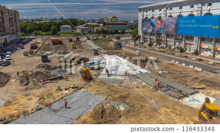 Excavator working on earthmoving at open pit mining in the city street timelapse. 116433348