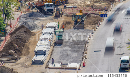 Green vibration roller compactor rolls on a stones at road construction and repairing timelapse Green vibration roller compactor rolls on a stones at road construction and repairing timelapse 116433356