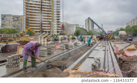 Gray construction telescopic crane unloading tram rails from truck timelapse. 116433377