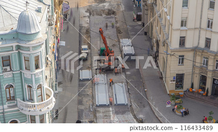 Installing concrete plates by crane at road construction site timelapse. 116433489