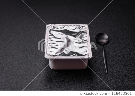 Rectangular plastic box with yogurt or cheese hermetically sealed with a foil lid 116433501