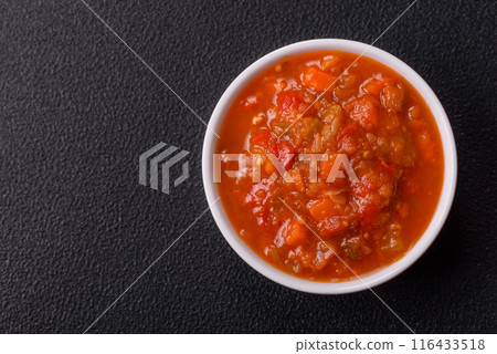 Red hot or spicy sauce with chili peppers, tomatoes, garlic, spices 116433518