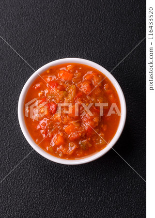 Red hot or spicy sauce with chili peppers, tomatoes, garlic, spices Red hot or spicy sauce with chili peppers, tomatoes, garlic, spices 116433520