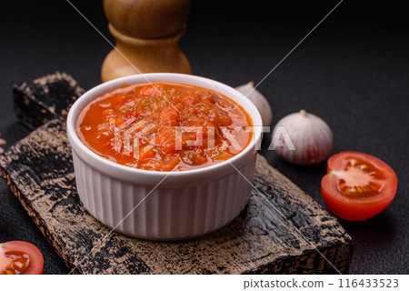 Red hot or spicy sauce with chili peppers, tomatoes, garlic, spices Red hot or spicy sauce with chili peppers, tomatoes, garlic, spices 116433523