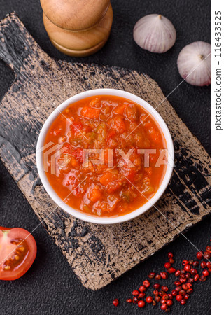 Red hot or spicy sauce with chili peppers, tomatoes, garlic, spices Red hot or spicy sauce with chili peppers, tomatoes, garlic, spices 116433525