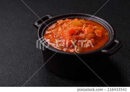 Red hot or spicy sauce with chili peppers, tomatoes, garlic, spices Red hot or spicy sauce with chili peppers, tomatoes, garlic, spices 116433541