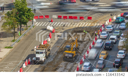 Industrial truck loader excavator moving soil and unloading into a dumper truck timelapse 116433542