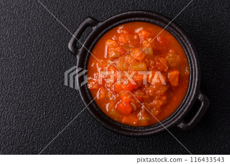 Red hot or spicy sauce with chili peppers, tomatoes, garlic, spices Red hot or spicy sauce with chili peppers, tomatoes, garlic, spices 116433543
