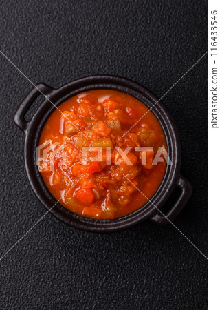 Red hot or spicy sauce with chili peppers, tomatoes, garlic, spices Red hot or spicy sauce with chili peppers, tomatoes, garlic, spices 116433546