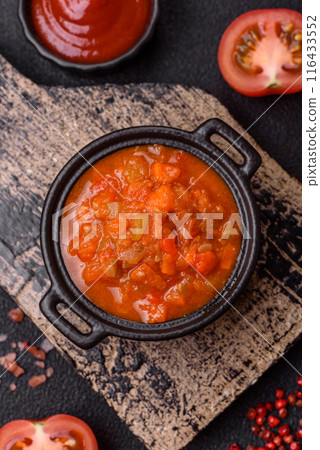 Red hot or spicy sauce with chili peppers, tomatoes, garlic, spices 116433552