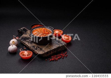 Red hot or spicy sauce with chili peppers, tomatoes, garlic, spices 116433555