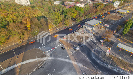 Construction site of avenue with asphalt paver, roller and truck aerial timelapse. 116433556