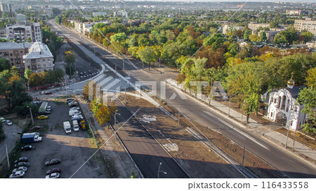 Construction site of avenue with asphalt paver, roller and truck aerial timelapse. Construction site of avenue with asphalt paver, roller and truck aerial timelapse. 116433558