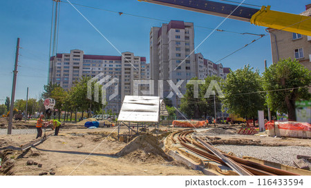 Yellow construction telescopic crane moving tram rails timelapse. Yellow construction telescopic crane moving tram rails timelapse. 116433594
