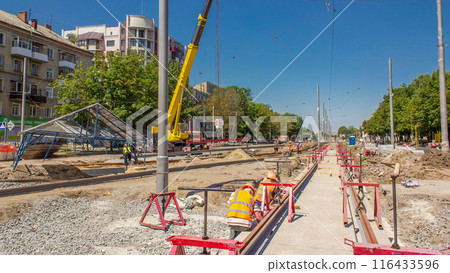 Yellow construction telescopic mobile crane moving tram rails timelapse. Yellow construction telescopic mobile crane moving tram rails timelapse. 116433596