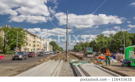 Concrete pouring between plates for road maintenance construction with many workers and mixer timelapse 116433638