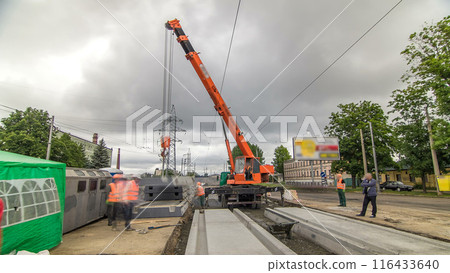 Unloading concrete plates at road construction site timelapse. Unloading concrete plates at road construction site timelapse. 116433640