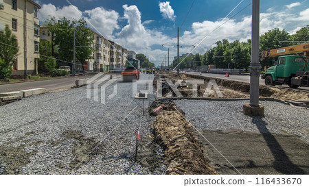 Orange vibration roller compactor rolls on a stones at road construction and repairing timelapse Orange vibration roller compactor rolls on a stones at road construction and repairing timelapse 116433670