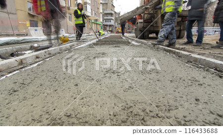 Pouring ready-mixed concrete after placing steel reinforcement to make the road by concrete mixer timelapse hyperlapse. Pouring ready-mixed concrete after placing steel reinforcement to make the road by concrete mixer timelapse hyperlapse. 116433688