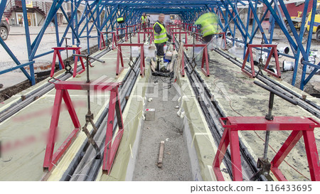 Tram rails at the stage of their installation and integration into concrete plates on the road timelapse. Tram rails at the stage of their installation and integration into concrete plates on the road timelapse. 116433695