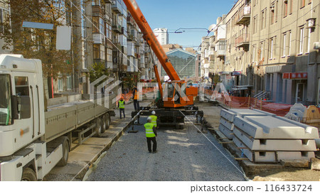 Unloading concrete plates from truck by crane at road construction site timelapse. Unloading concrete plates from truck by crane at road construction site timelapse. 116433724