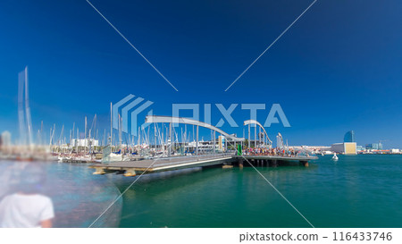 Rambla de Mar wooden walkway timelapse over Port Vell in the city of Barcelona at day in Catalonia, Spain. Rambla de Mar wooden walkway timelapse over Port Vell in the city of Barcelona at day in Catalonia, Spain. 116433746