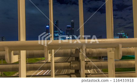 Skyscrapers and transport metropolis timelapse hyperlapse, traffic and lights of cars on multi-lane highways and road junction 116433918
