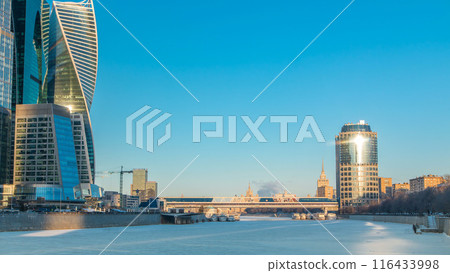 Moscow City skyscrapers and frozen river in winter at sunset timelapse. 116433998