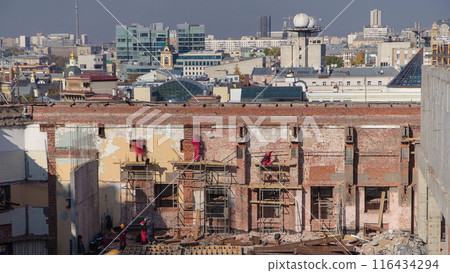 Bricklayers laying bricks to repair old walls timelapse. 116434294