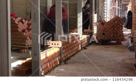 Bricklayers laying bricks to make a walls timelapse. Bricklayers laying bricks to make a walls timelapse. 116434296