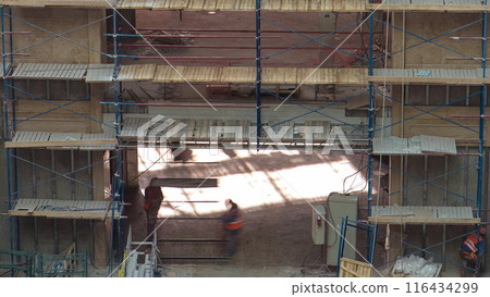 Construction equipment material with scaffolding and tools inside the floor of high rising building timelapse 116434299