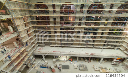 Construction equipment material with scaffolding and tools inside the floor of high rising building timelapse 116434304