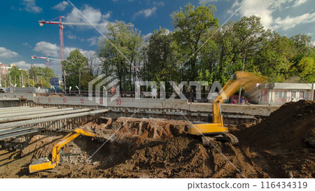 Yellow excavator and jackhammer machine on a construction site timelapse Yellow excavator and jackhammer machine on a construction site timelapse 116434319