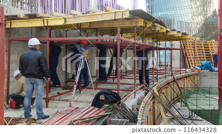 Construction workers working on steel rods used to reinforce concrete timelapse Construction workers working on steel rods used to reinforce concrete timelapse 116434328