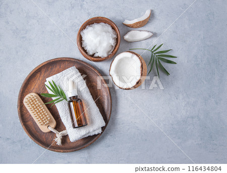concept of organic spa flat lay. Healthy coconut oil with a wooden brush and half a coconut  116434804