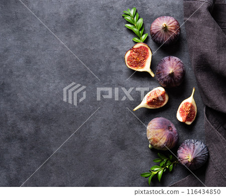 Fresh ripe figs, slices and napkin on a dark gray background. Concept healthy food. Copy space  116434850