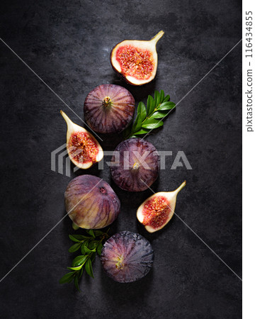 Flat lay with fresh ripe figs on a dark gray background. Concept healthy food. Copy space Flat lay with fresh ripe figs on a dark gray background. Concept healthy food. Copy space 116434855