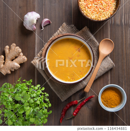 Masala soup. Indian national dish with curry, chili pepper and red lentil. Top view 116434881