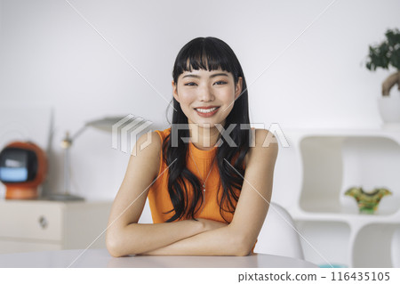 A young woman smiling looking at the camera 116435105