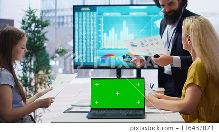 Financial adviser doing presentation on isolated screen laptop to help clients build saving habits, close up. Agent using chroma key notebook to show customers investing tips, camera B 116437071