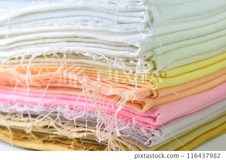stack of colourful cotton clothes, close up pile of clothing 116437982