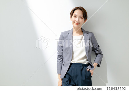 A woman standing with a smile A woman standing with a smile 116438592