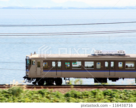 Kosei Line 113 series train passing Lake Biwa Kosei Line 113 series train passing Lake Biwa 116438716