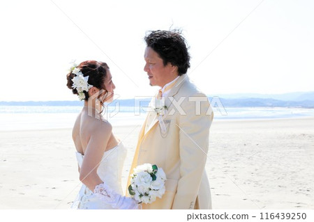 Bride in a wedding dress and groom in a tuxedo Photo wedding beach location shoot Bride in a wedding dress and groom in a tuxedo Photo wedding beach location shoot 116439250