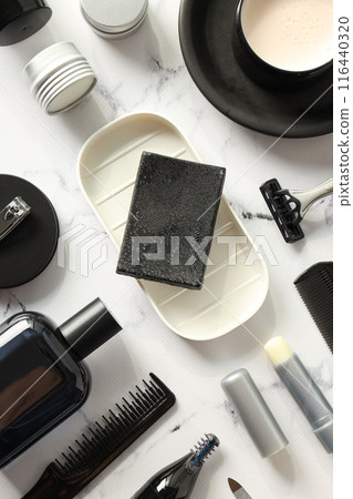Bottles and jars with men's cosmetics, soap and shaving tools on marble background, top view Bottles and jars with men's cosmetics, soap and shaving tools on marble background, top view 116440320