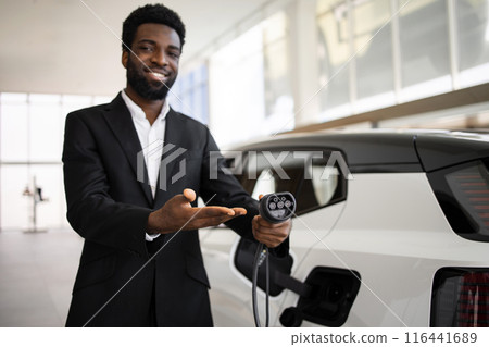 Dealer promotes electric SUV at modern car dealership Dealer promotes electric SUV at modern car dealership 116441689