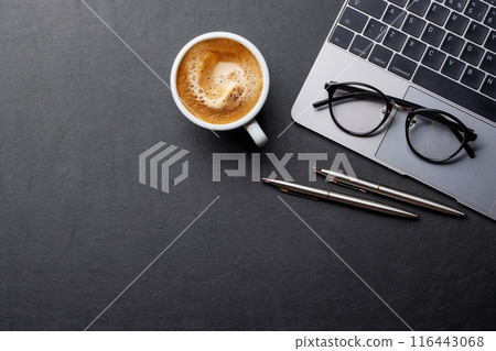 Office desk table with laptop, cup of coffee and supplies 116443068