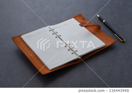 Image of a ring-type system organizer being opened and writing a diary Image of a ring-type system organizer being opened and writing a diary 116443948